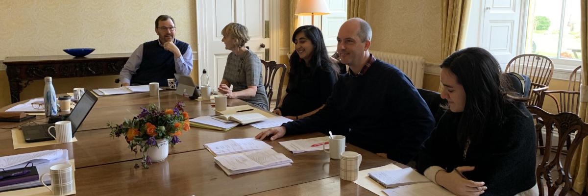 Scholars around a Collaborative Workshop Table 